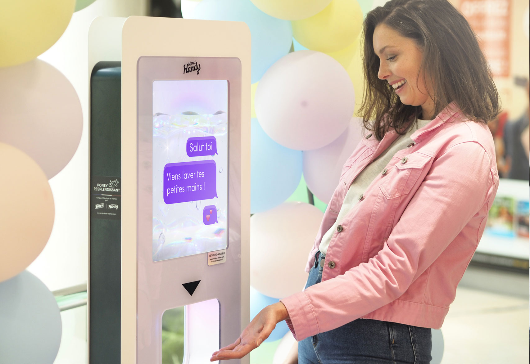 A smiling visitor answers on the screen of a Data Station